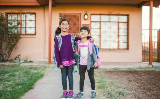 Girls Giggling in Front Yard of Their Home