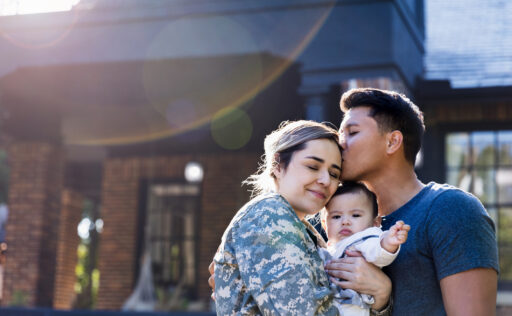 latino family in front of house.